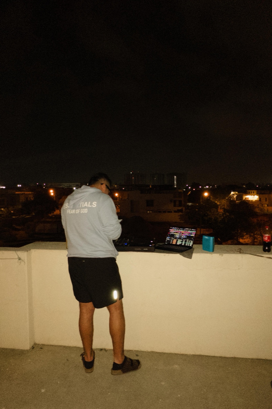 Afro house on a Karachi rooftop, laptop and a Coke.